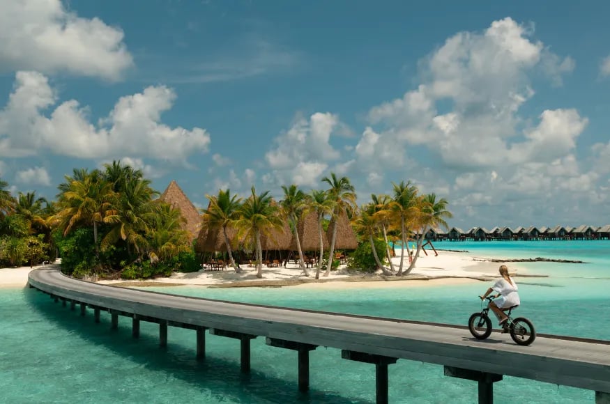 Woman cycling at Heritance Aarah The Maldives